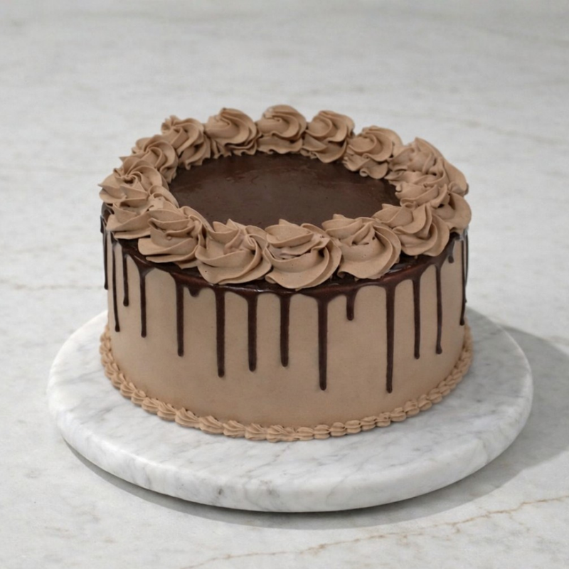 Chocolate cake with chocolate frosting on a marble surface