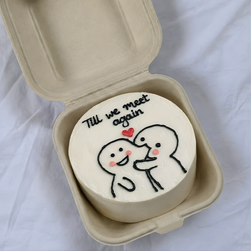 Round white object with cartoon characters and 'Till we meet again' text in a beige container on a light background