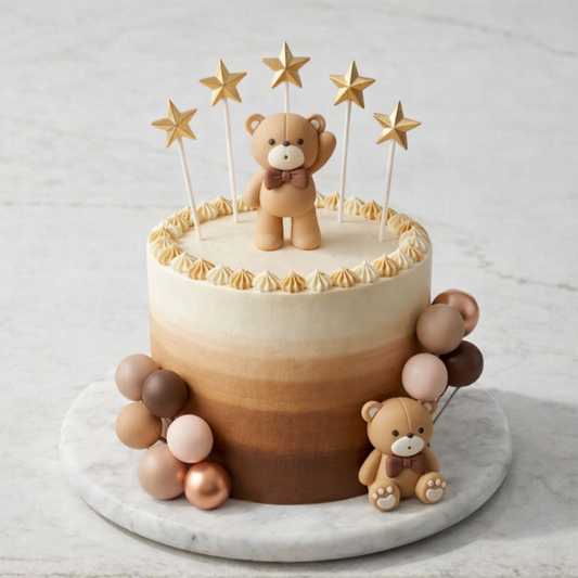 Cake with teddy bear decoration on a marble board