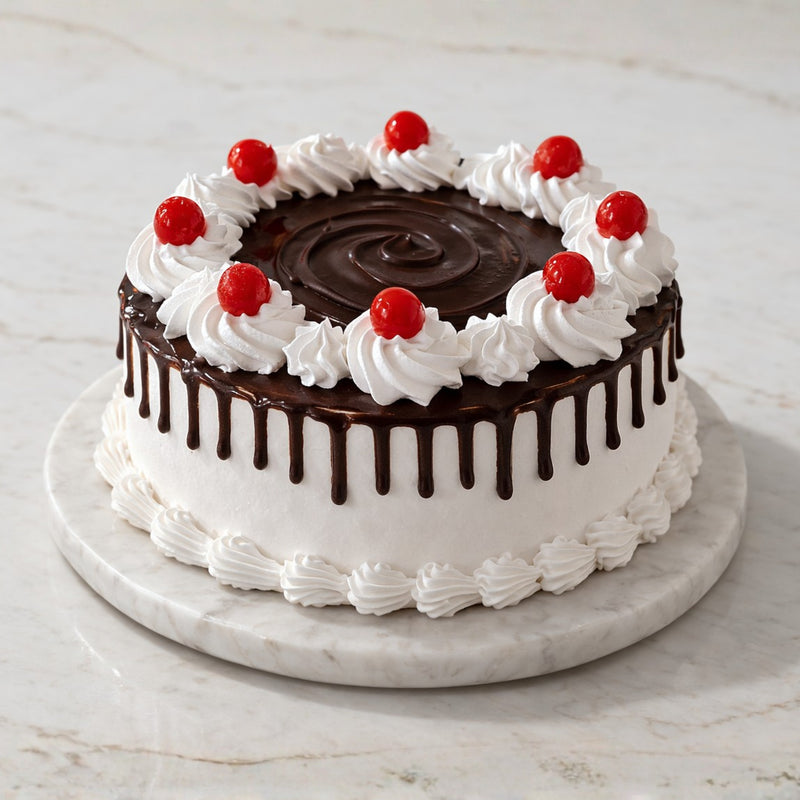 Black Forest drip cake with whipped cream, chocolate ganache, and cherries on top of a marble cake stand.