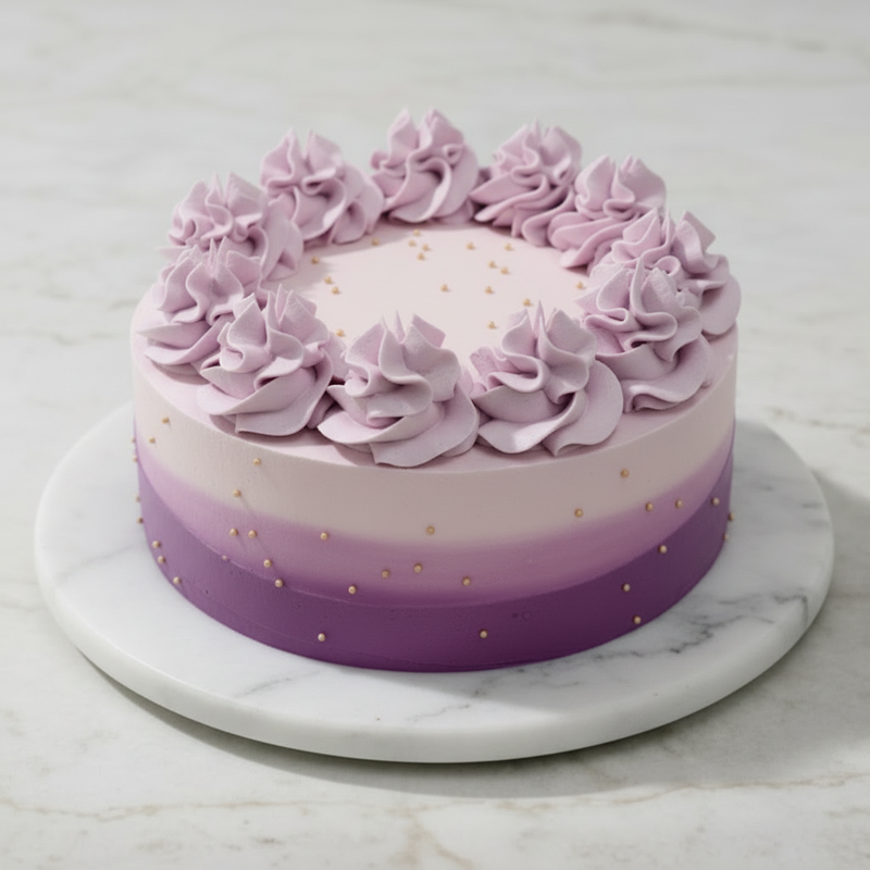 A layered cake with purple rosettes and gold pearl accents on a marble platter.