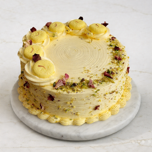 Decorative cake with white frosting and yellow elements on a marble stand.